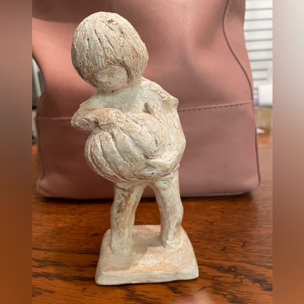 Vintage Austin sculpture of a boy carrying his pumpkin
